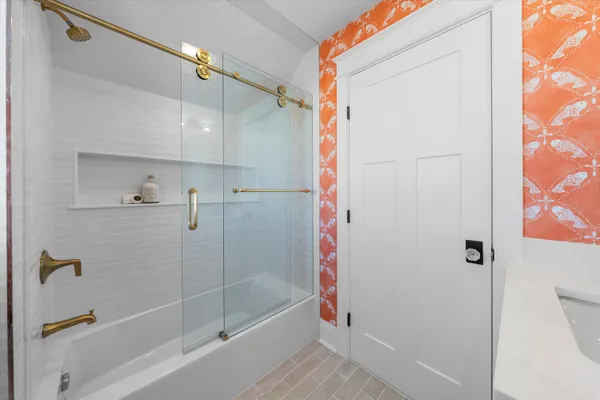 a bathroom with a bathtub and a shower