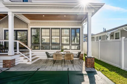 a view of a house with backyard porch and sitting area