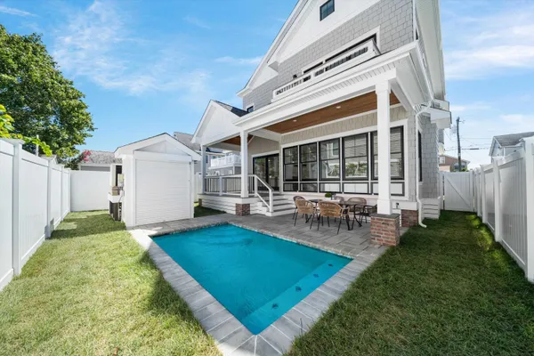 a view of a house with backyard porch and sitting area