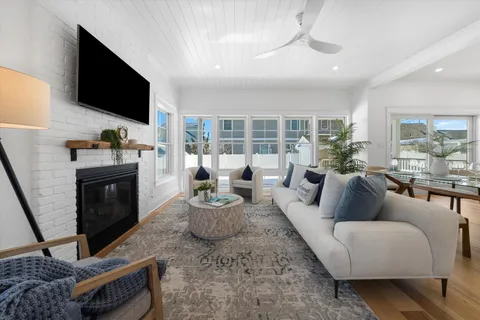 a living room with fireplace furniture and a flat screen tv