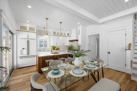 a dining room with furniture and wooden floor