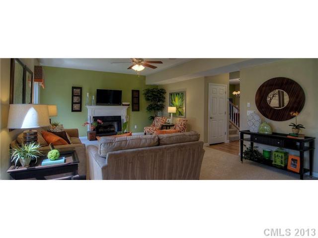 3003 Fallondale Road, Unit 855 Waxhaw, NC 28173 - Photo 1 of 2 a living room with furniture a fireplace and a flat screen tv