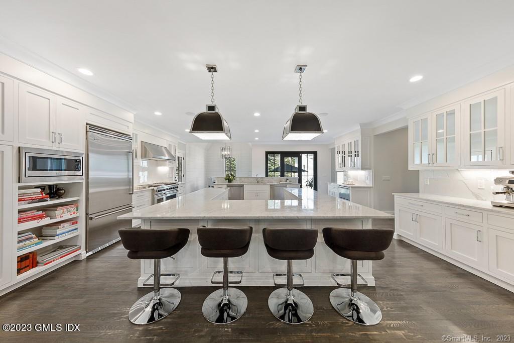 8 S Trail Darien, CT 06820 - Photo 8 of 38 a kitchen with a dining table chairs sink and cabinets