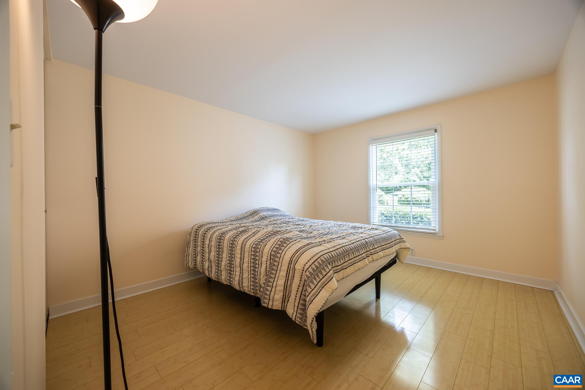 2527 Hydraulic Road, Unit 41 Charlottesville, VA 22901 - Photo 12 of 16 a bedroom with a bed and a window