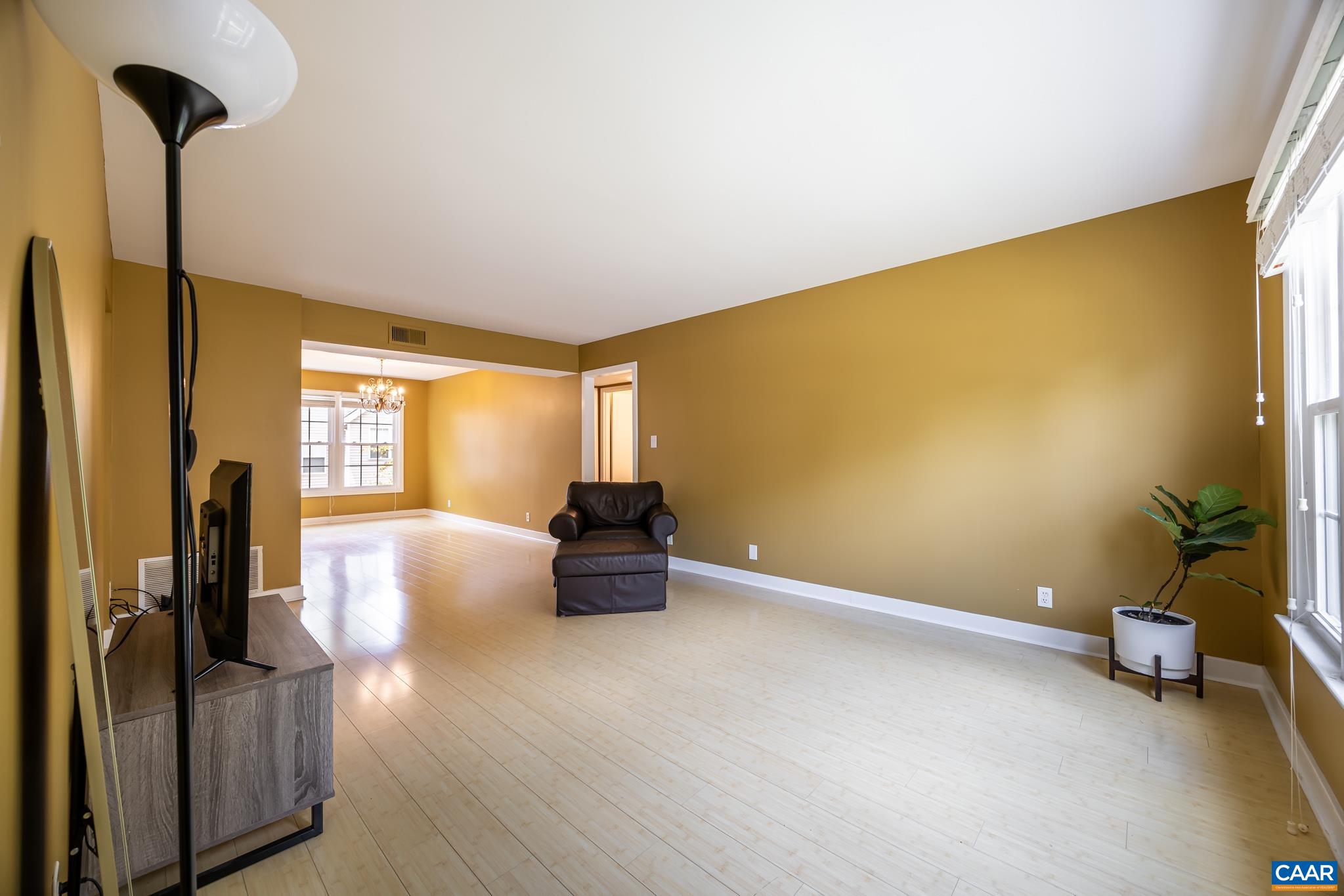 2527 Hydraulic Road, Unit 41 Charlottesville, VA 22901 - Photo 5 of 16 a view of empty room with wooden floor and fan