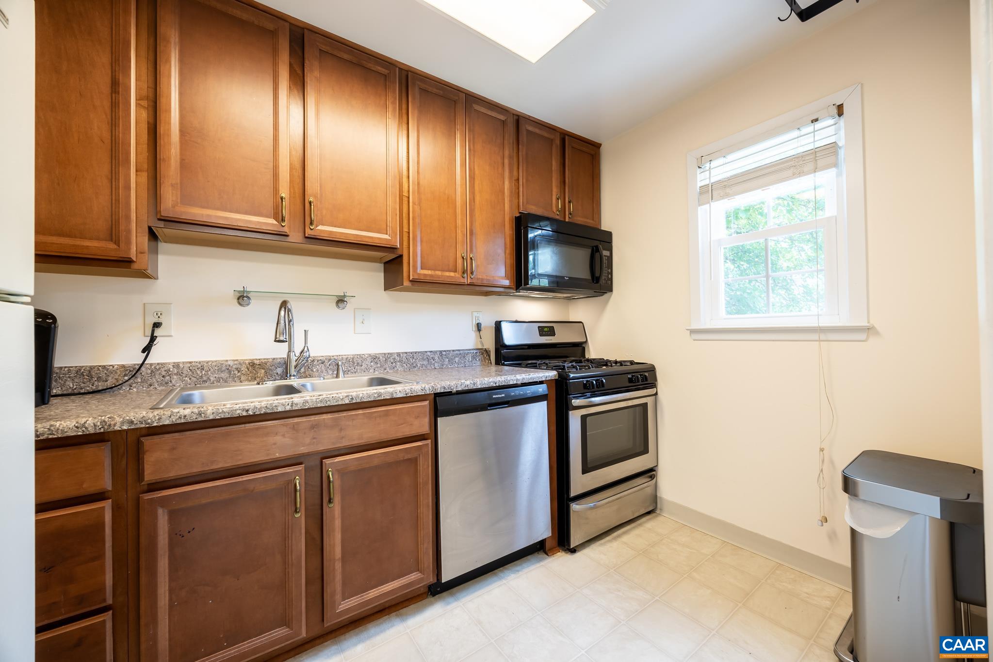 2527 Hydraulic Road, Unit 41 Charlottesville, VA 22901 - Photo 8 of 16 a kitchen with stainless steel appliances granite countertop a sink stove and microwave
