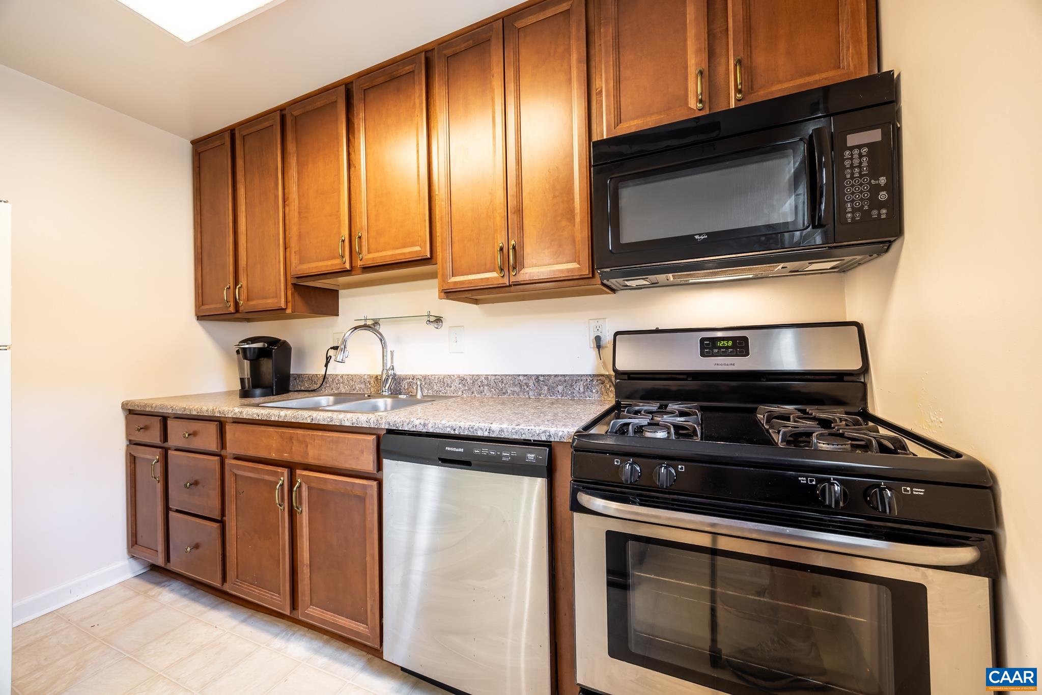 2527 Hydraulic Road, Unit 41 Charlottesville, VA 22901 - Photo 9 of 16 a kitchen with a stove and a microwave