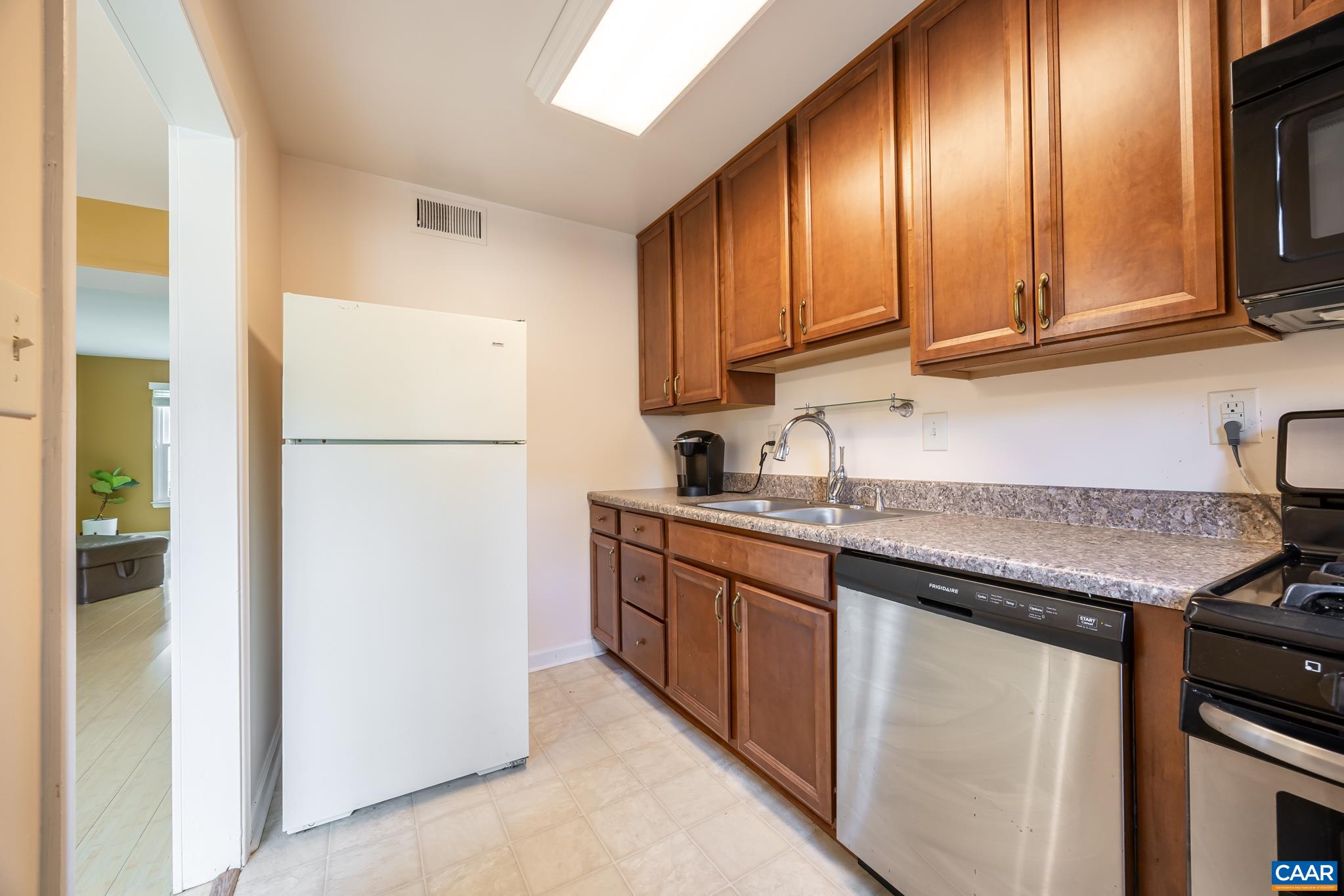 2527 Hydraulic Road, Unit 41 Charlottesville, VA 22901 - Photo 10 of 16 a kitchen with granite countertop stainless steel appliances a refrigerator a sink and cabinets