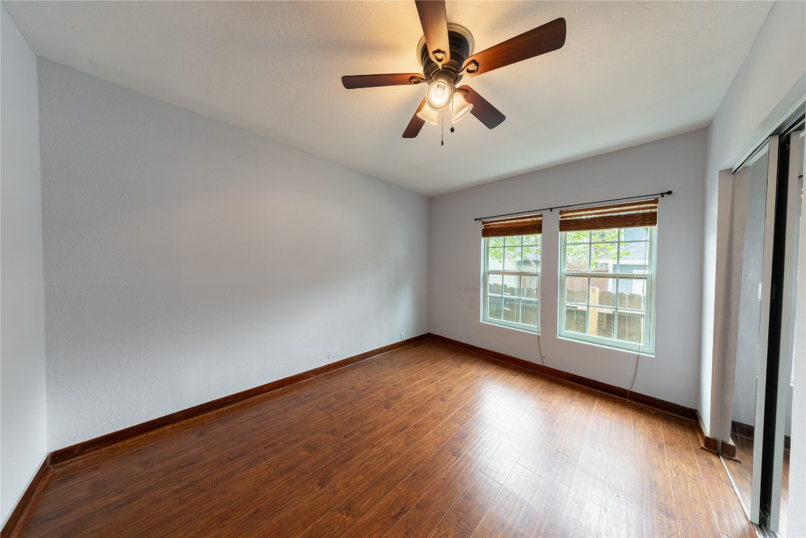 1229 West 21st Street Houston, TX 77008 - Photo 16 of 25 an empty room with wooden floor fan and windows
