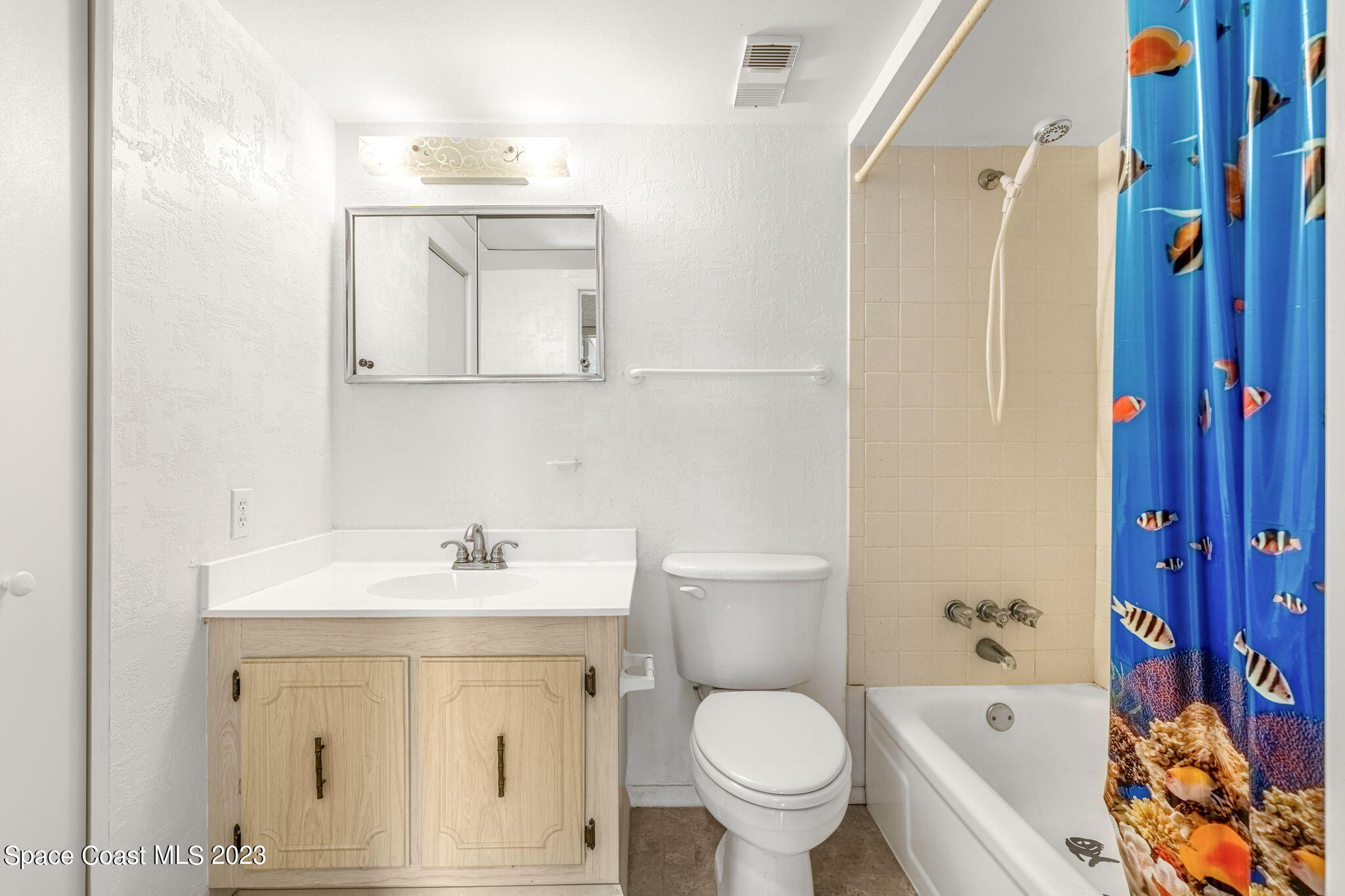 877 N Highway, Unit 1304 Indialantic, FL 32903 - Photo 12 of 24 a bathroom with a sink toilet and shower