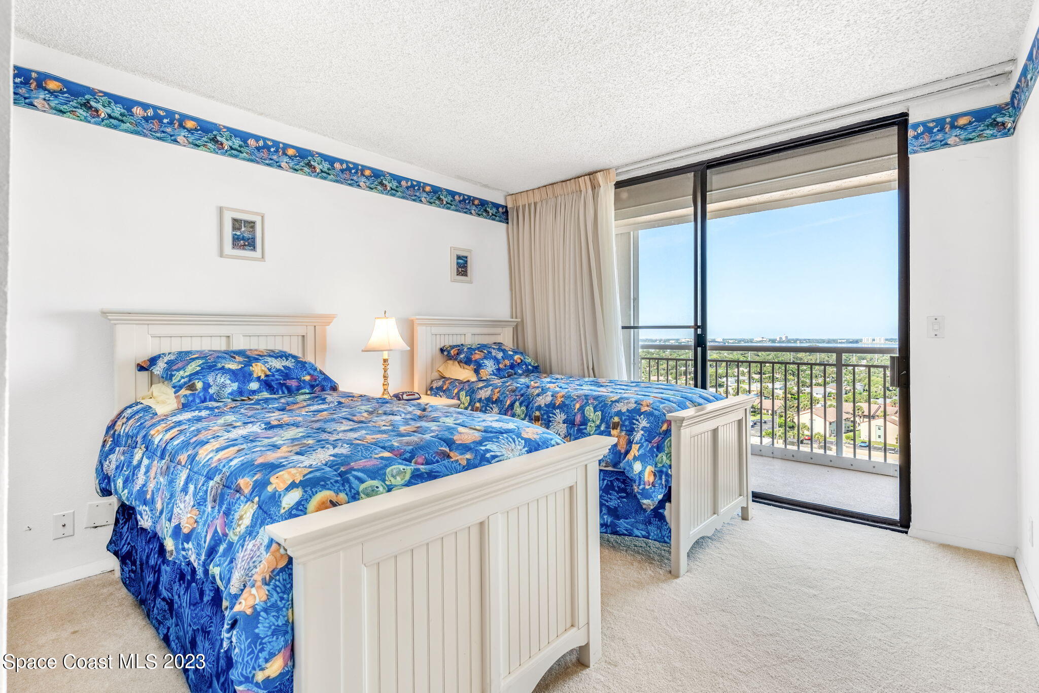 877 N Highway, Unit 1304 Indialantic, FL 32903 - Photo 13 of 24 a bedroom with three beds and large window