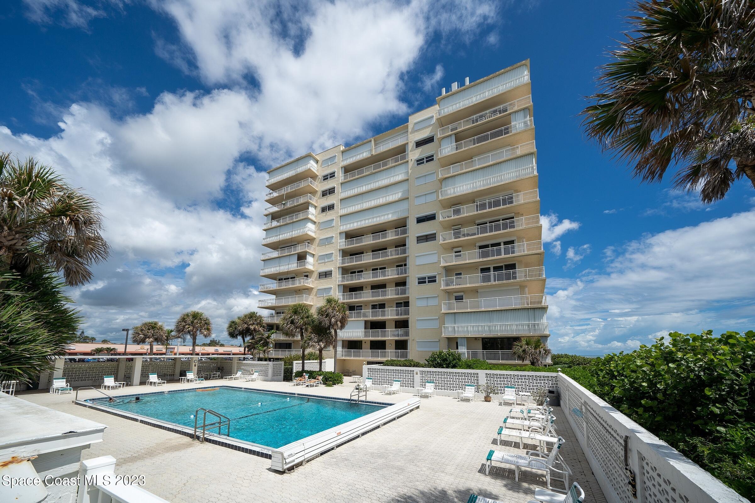 877 N Highway, Unit 1304 Indialantic, FL 32903 - Photo 18 of 24 a front view of a building with a yard