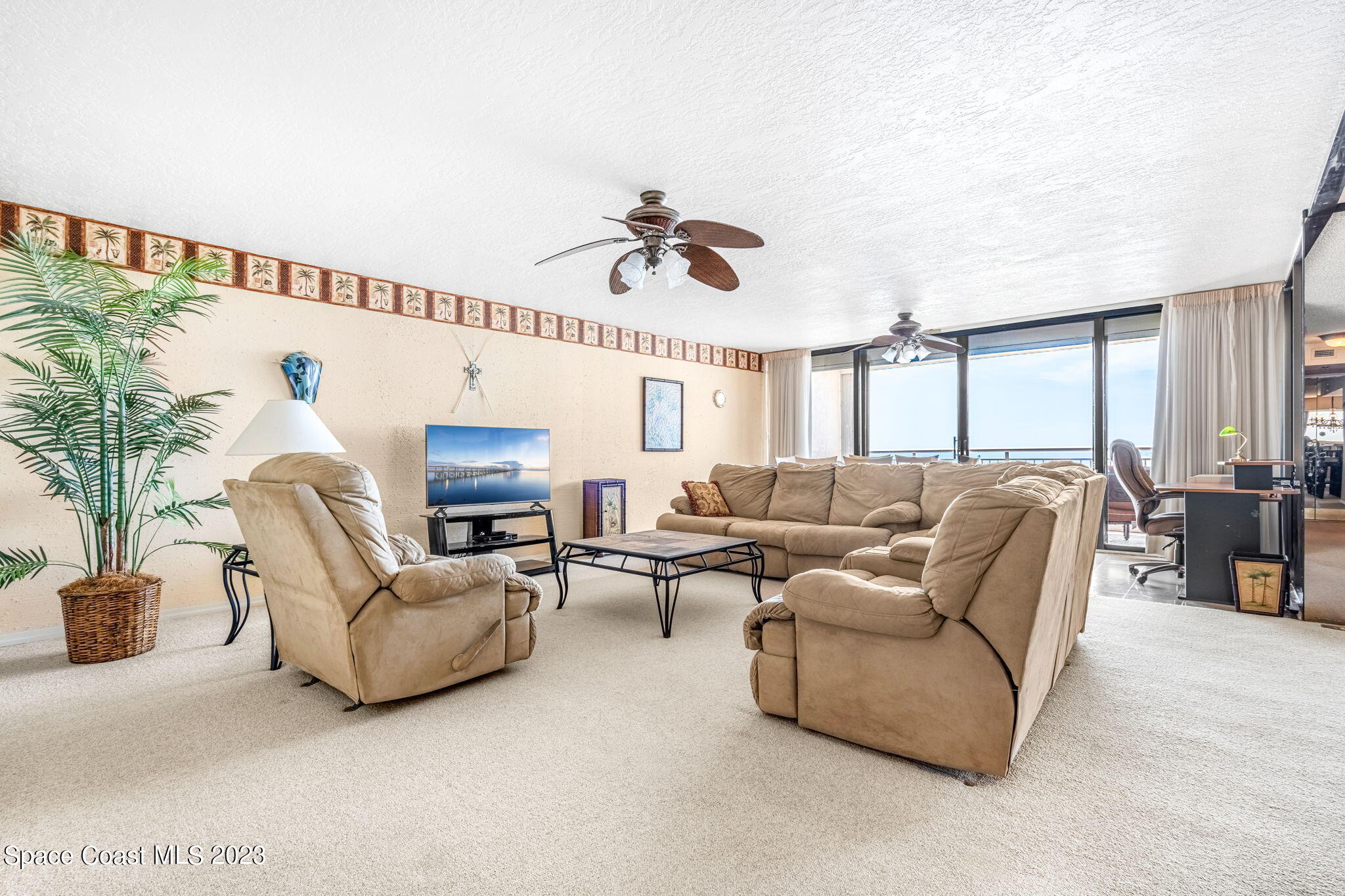 877 N Highway, Unit 1304 Indialantic, FL 32903 - Photo 6 of 24 a living room with furniture ceiling fan and a rug
