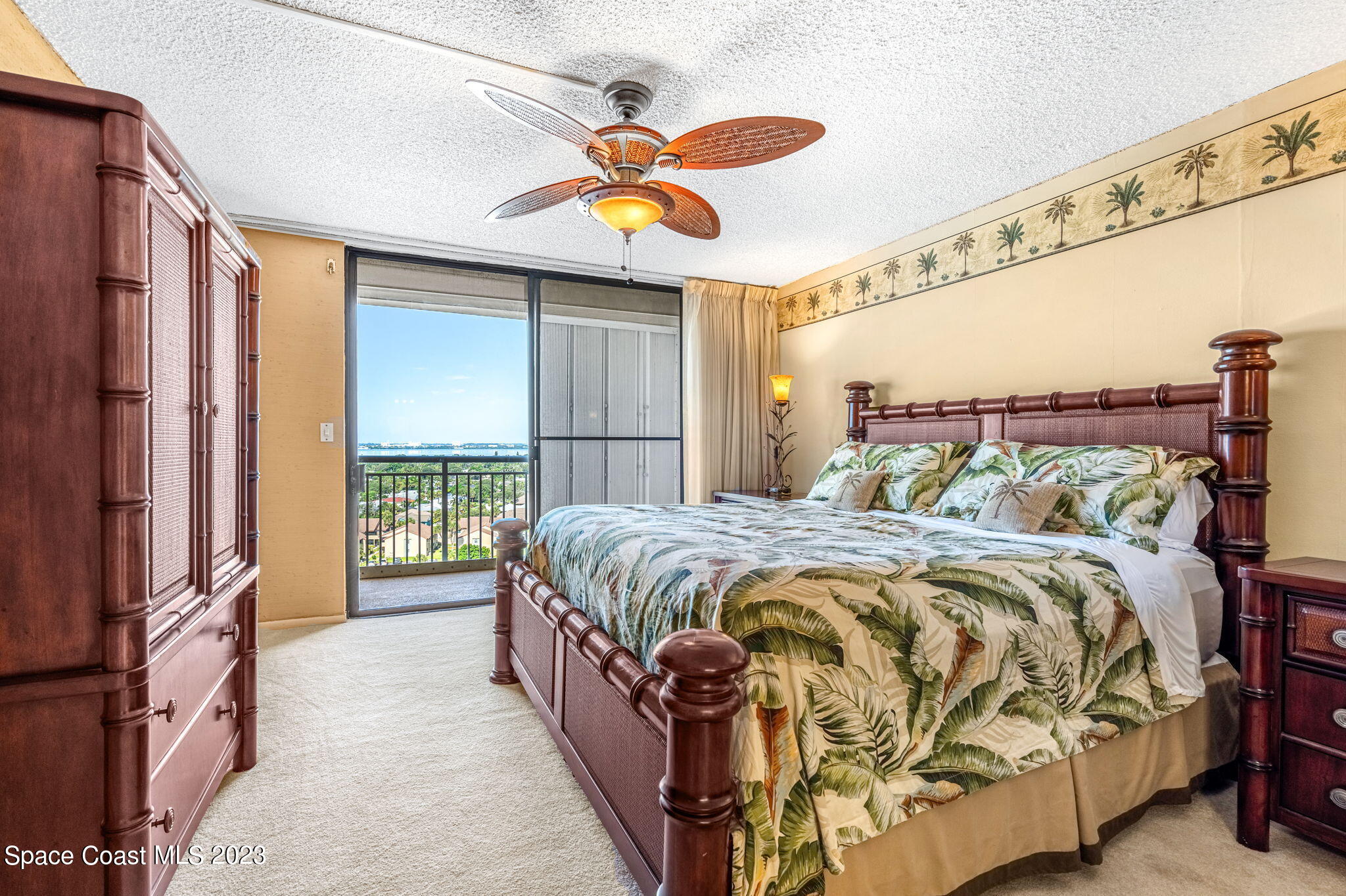 877 N Highway, Unit 1304 Indialantic, FL 32903 - Photo 8 of 24 a bedroom with a bed and a chandelier