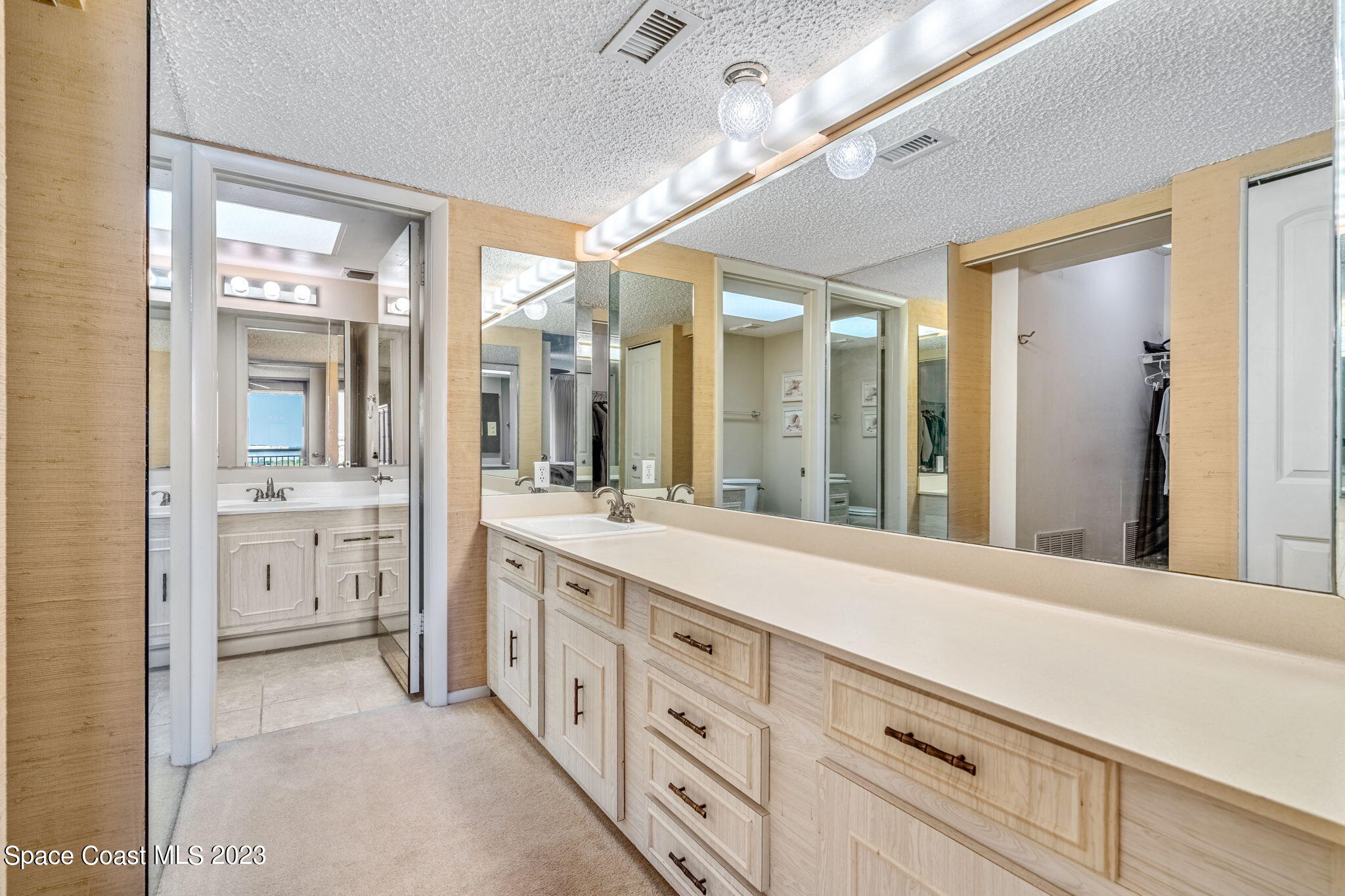 877 N Highway, Unit 1304 Indialantic, FL 32903 - Photo 9 of 24 a spacious bathroom with a granite countertop sink mirror and a shower