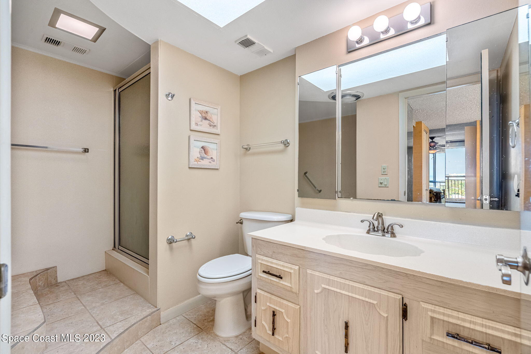 877 N Highway, Unit 1304 Indialantic, FL 32903 - Photo 10 of 24 a bathroom with a sink toilet and shower