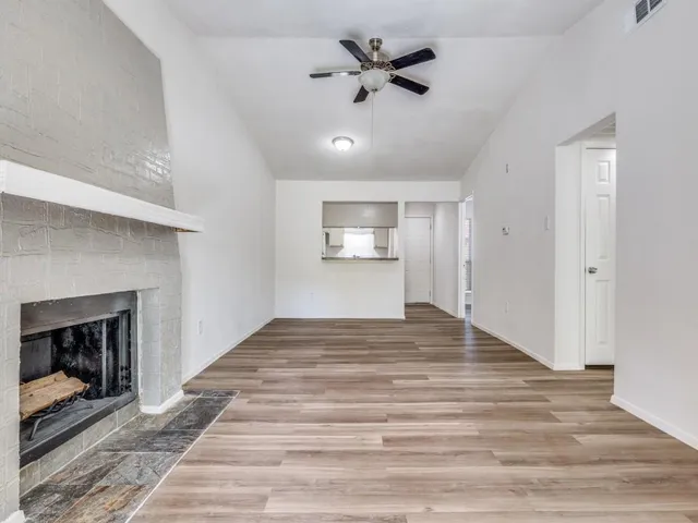 a view of an empty room and fire place