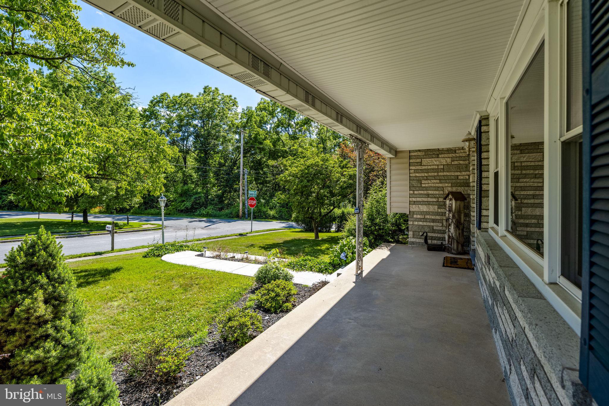 4107 Trowbridge Road York, PA 17402 - Photo 34 of 50 Charming porch with lush greenery.