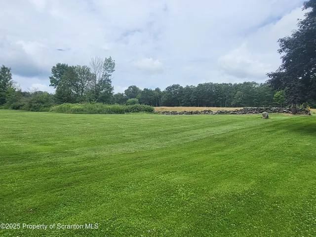 a view of a hallway with furniture and a window