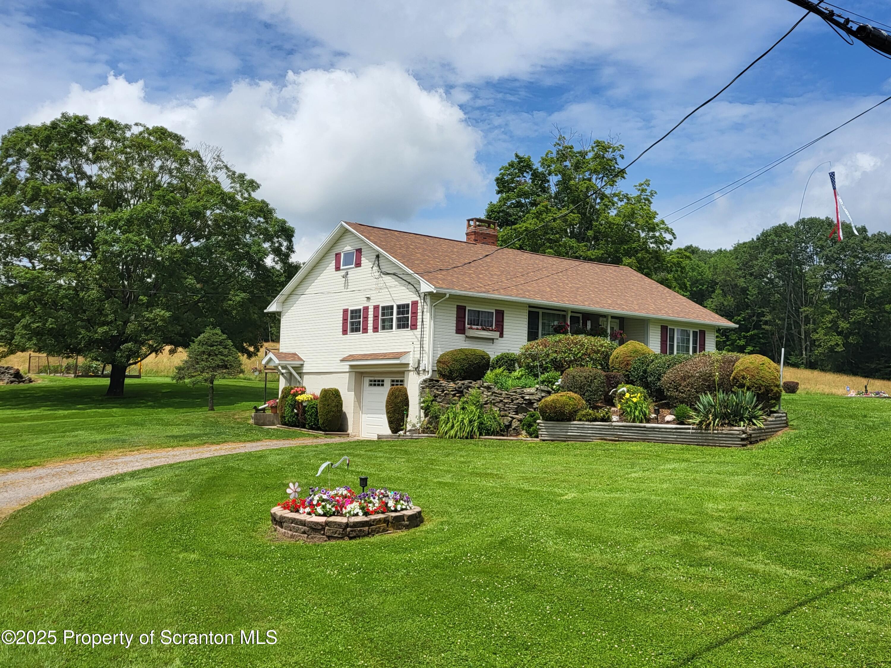 520 State Rte 2010 Forest City, PA 18421 - Photo 2 of 99 a front view of a house with a garden