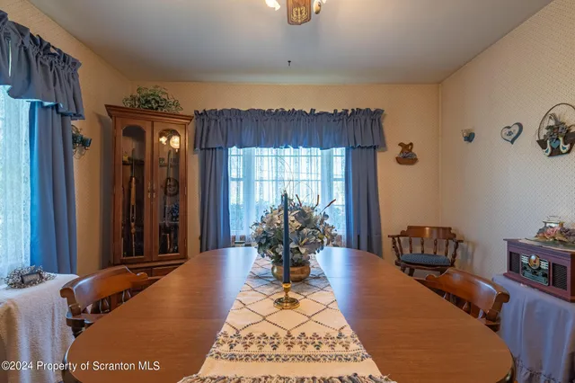 a front view of a house with garden and trees