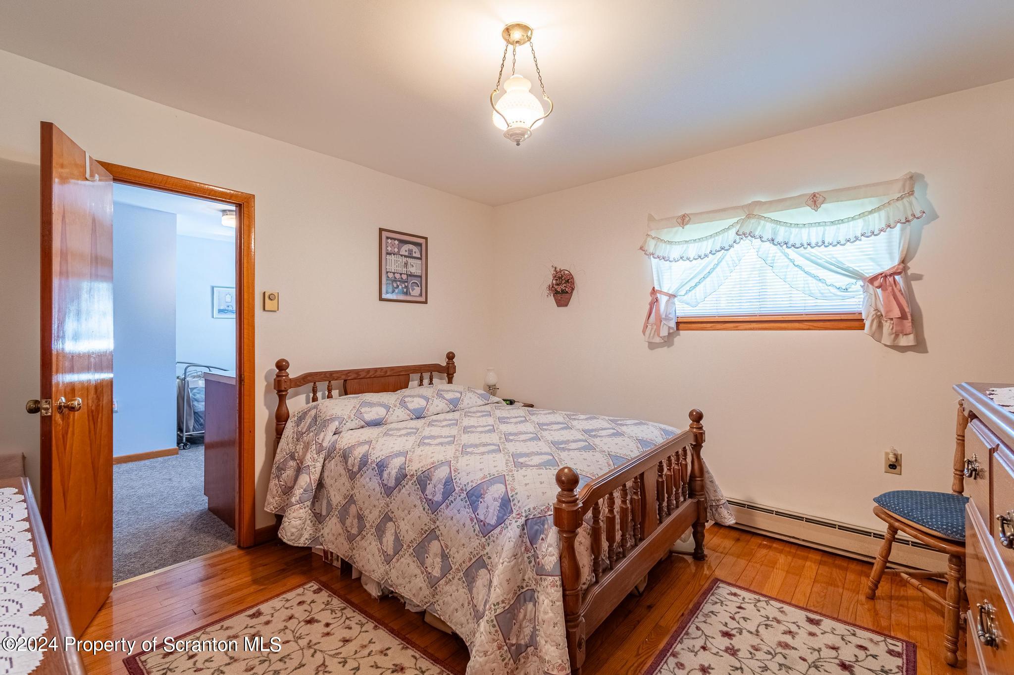 520 State Rte 2010 Forest City, PA 18421 - Photo 28 of 99 a bedroom with a bed and wooden floor