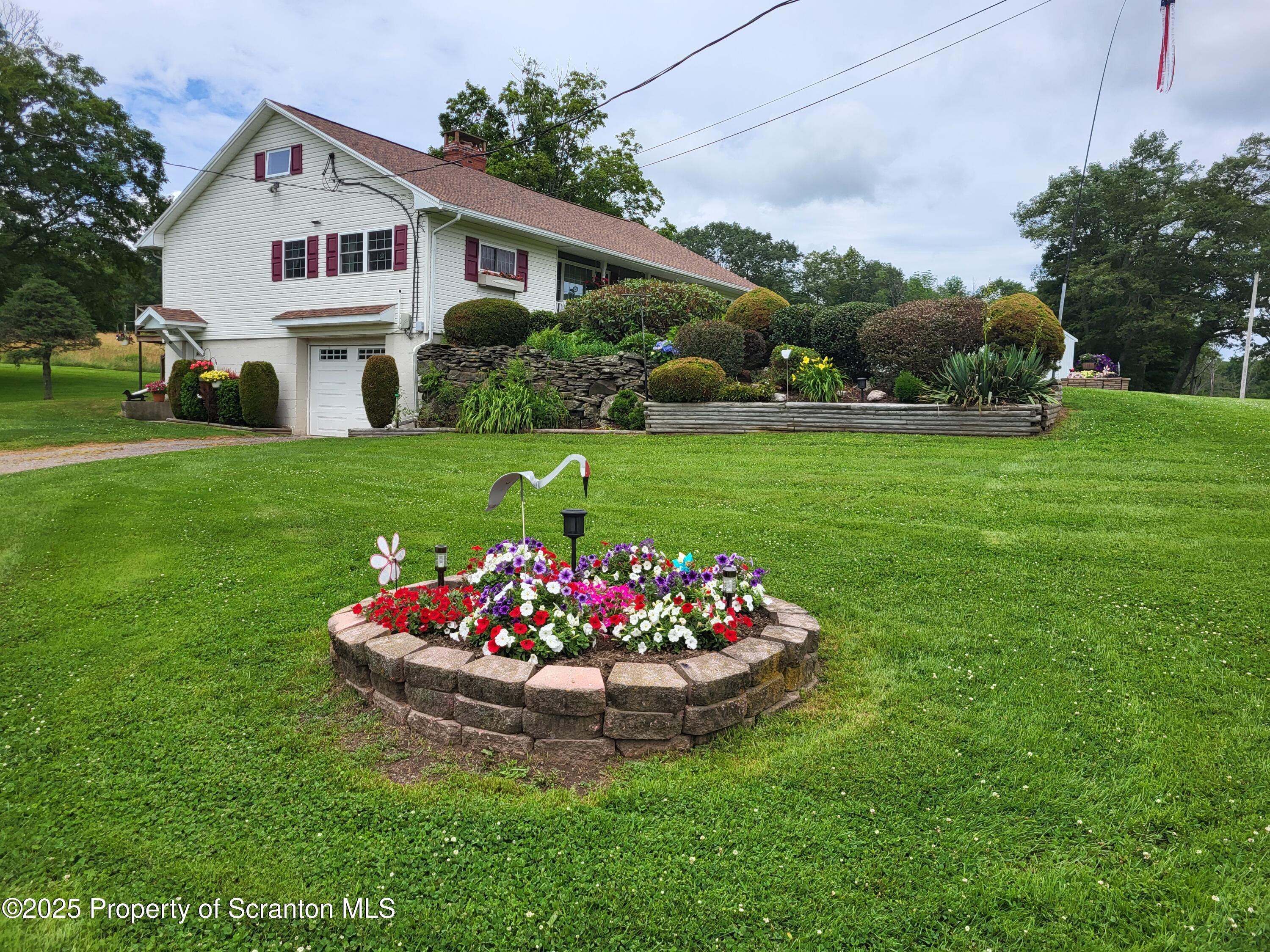520 State Rte 2010 Forest City, PA 18421 - Photo 43 of 99 a view of a white house with a yard and potted plants