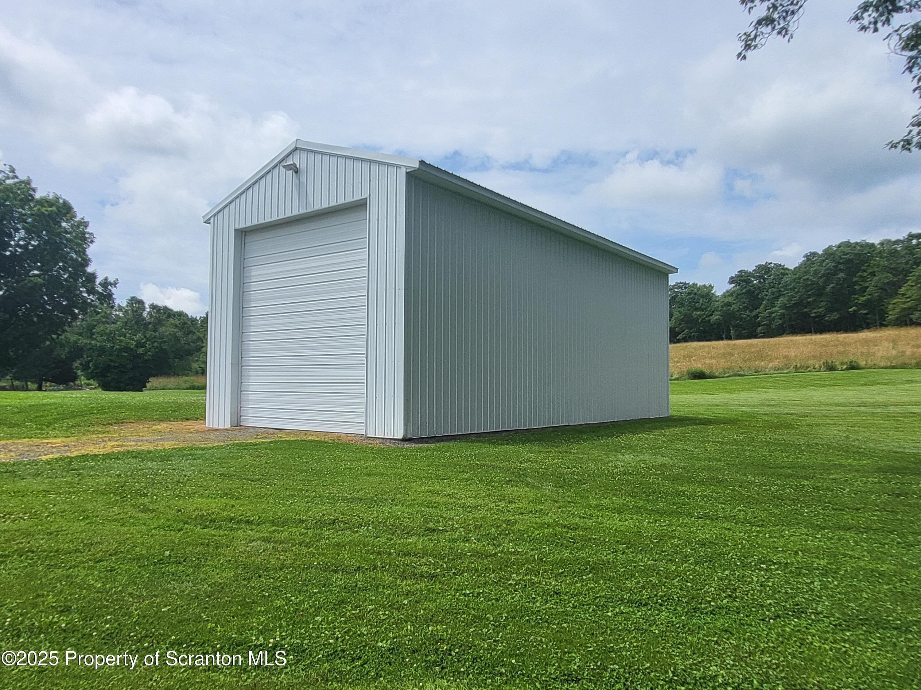 520 State Rte 2010 Forest City, PA 18421 - Photo 48 of 99 a backyard of a house with lots of green space and plants