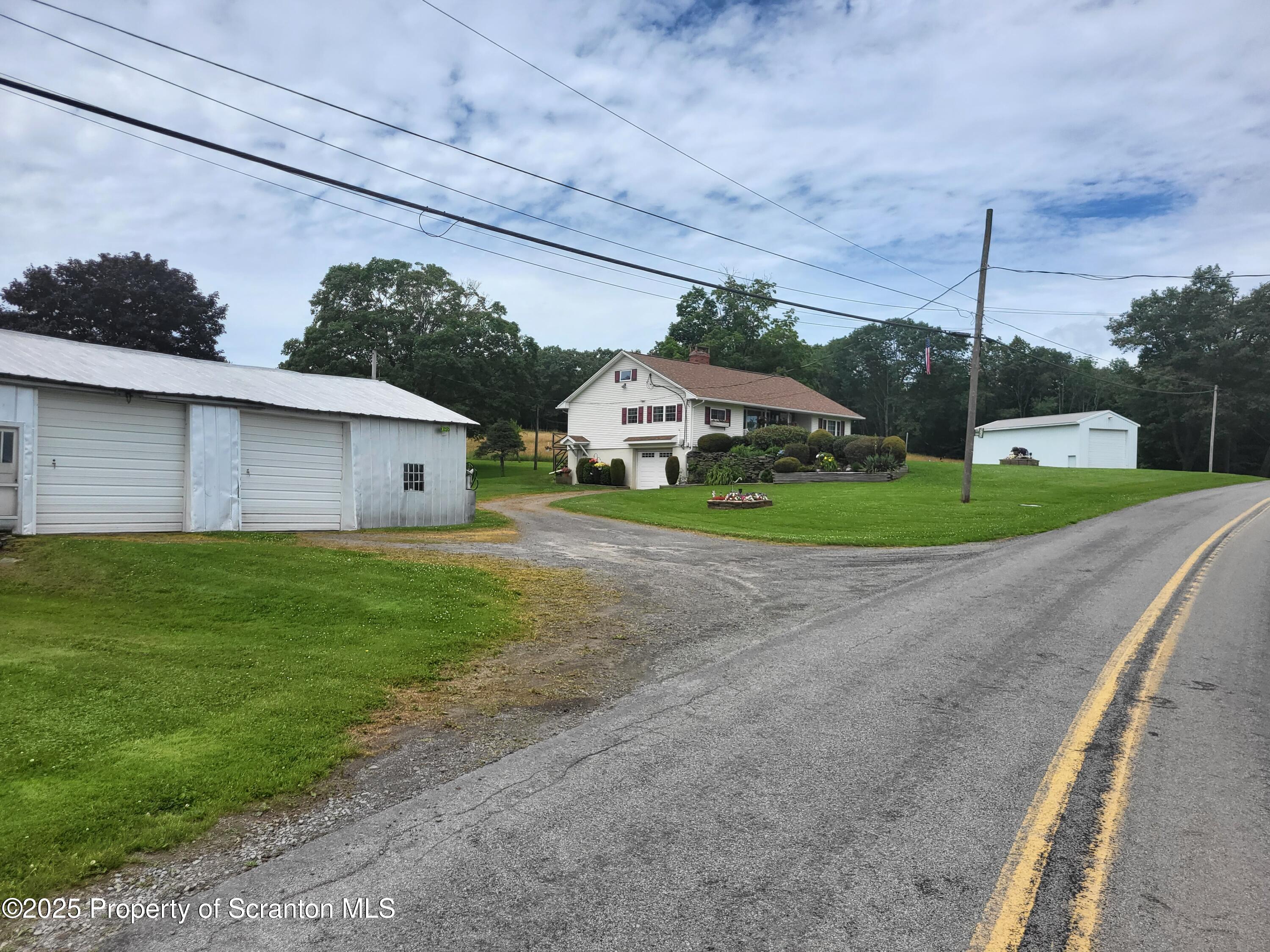 520 State Rte 2010 Forest City, PA 18421 - Photo 6 of 99 a front view of a house with a yard and garage