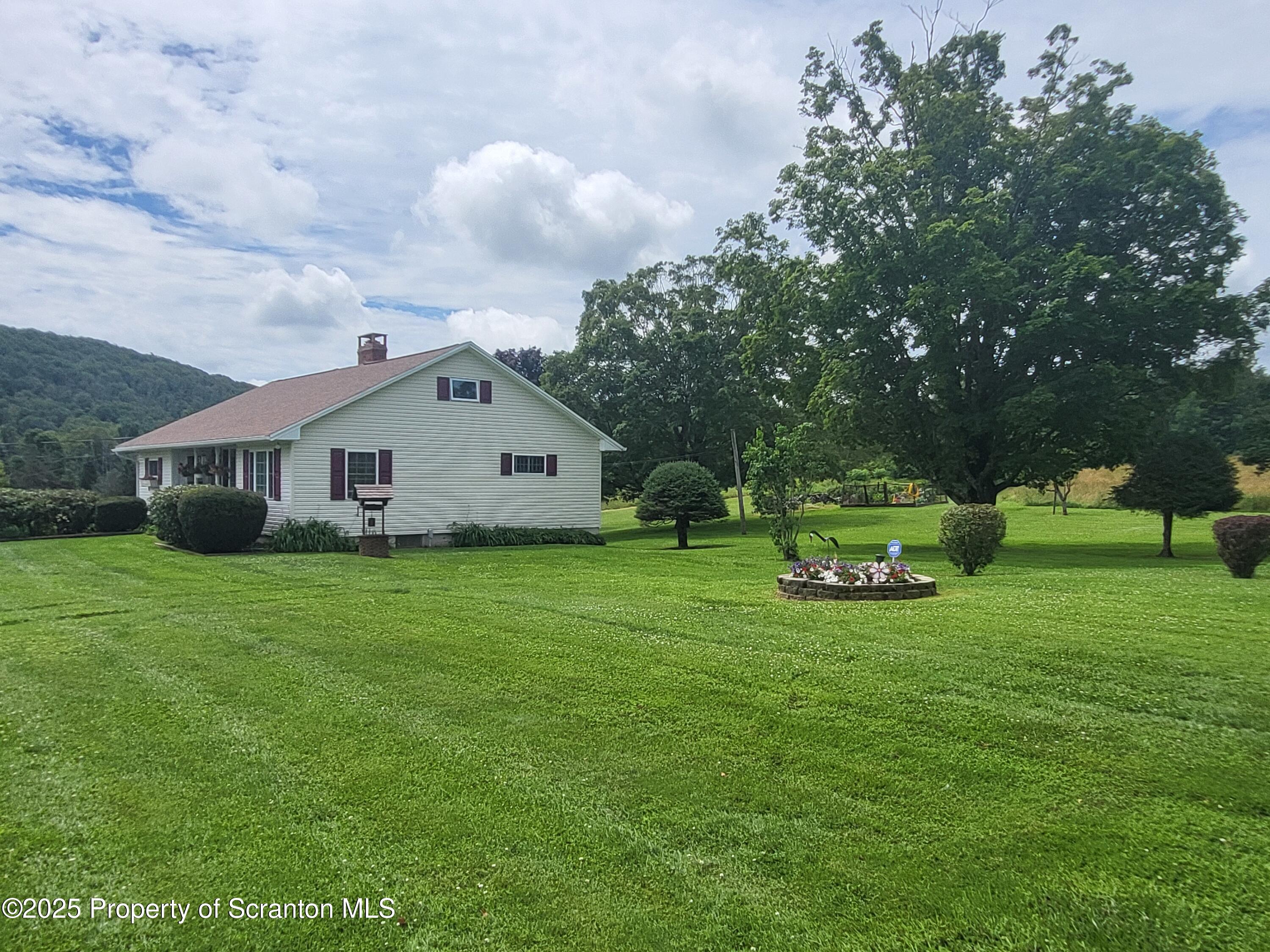 520 State Rte 2010 Forest City, PA 18421 - Photo 96 of 99 a front view of a house with garden and trees