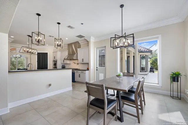 a view of a dining room and chandelier fan
