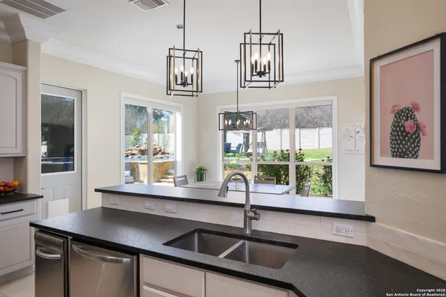 a kitchen with stainless steel appliances a sink and a window