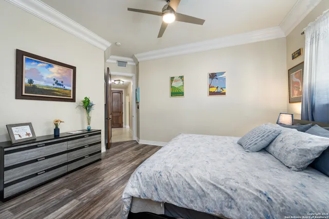 a bedroom with a bed and a painting on the wall