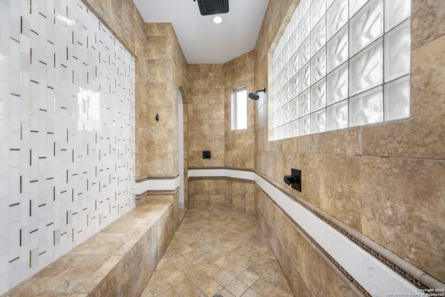 a bathroom with a bathtub and shower