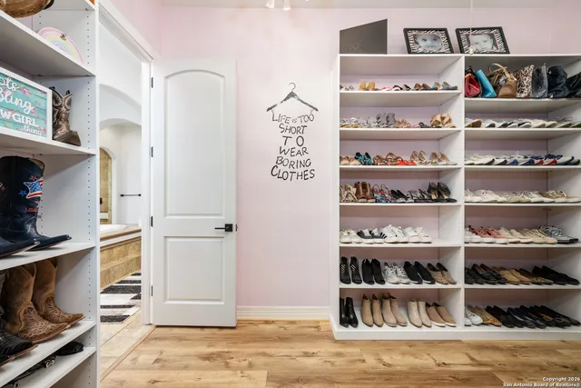 a view of a kitchen with shelves and wooden shelves