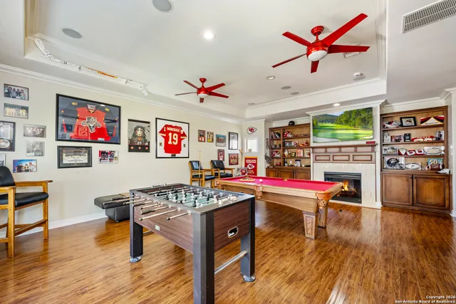 a living room with stainless steel appliances kitchen island granite countertop furniture and a wooden floor