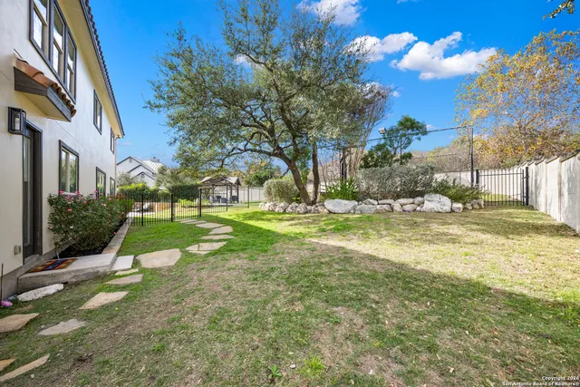 a view of backyard with swimming pool