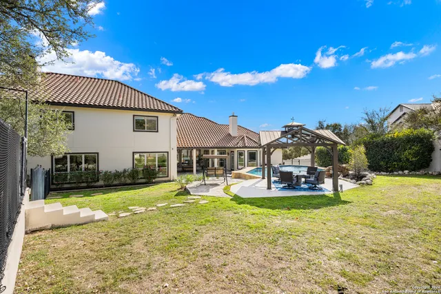 a view of a house with swimming pool and sitting area