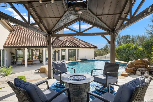 a view of a porch with furniture and a yard