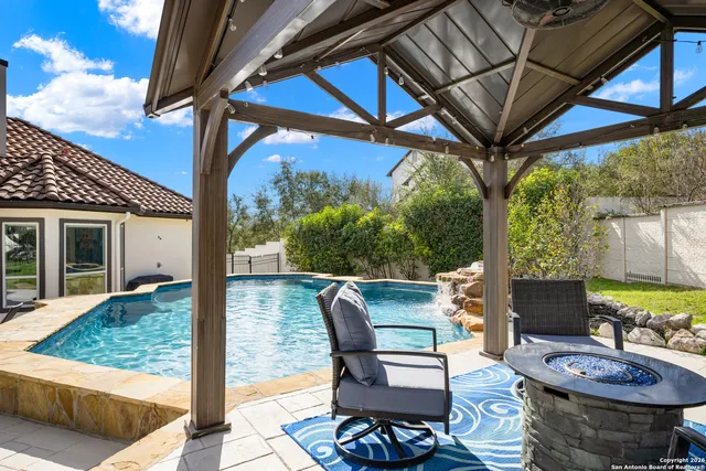 a view of a patio with table and chairs and potted plants