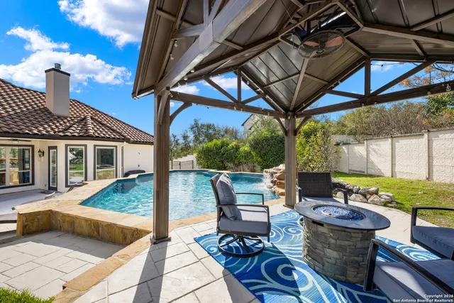 a view of a patio with table and chairs potted plants with wooden floor