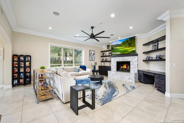 a living room with furniture a fireplace and a flat screen tv