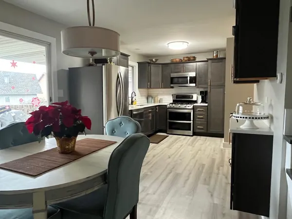 a kitchen with stainless steel appliances a stove refrigerator sink and microwave