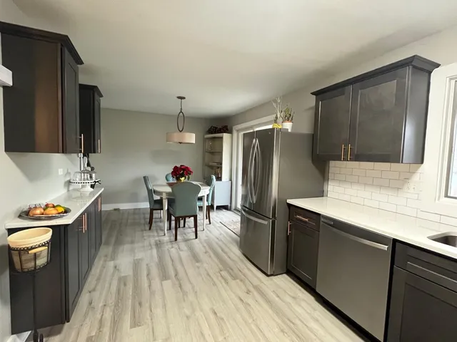 a kitchen with a sink appliances and cabinets