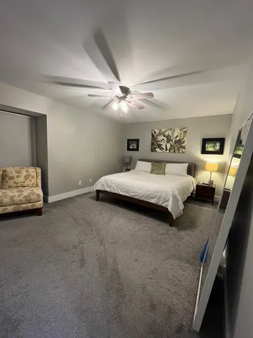 a bedroom with a bed and ceiling fan