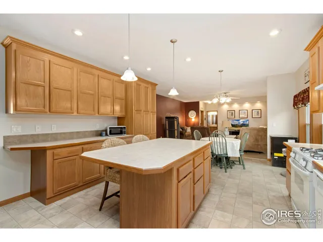 a large kitchen with a table and chairs
