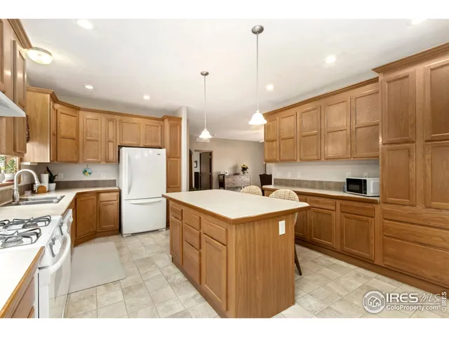 a kitchen with refrigerator cabinets and a sink