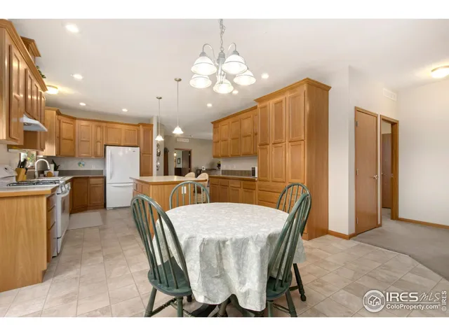 a kitchen with kitchen island a refrigerator and a sink