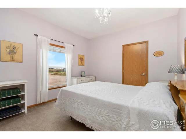 a bedroom with a bed and a cabinet