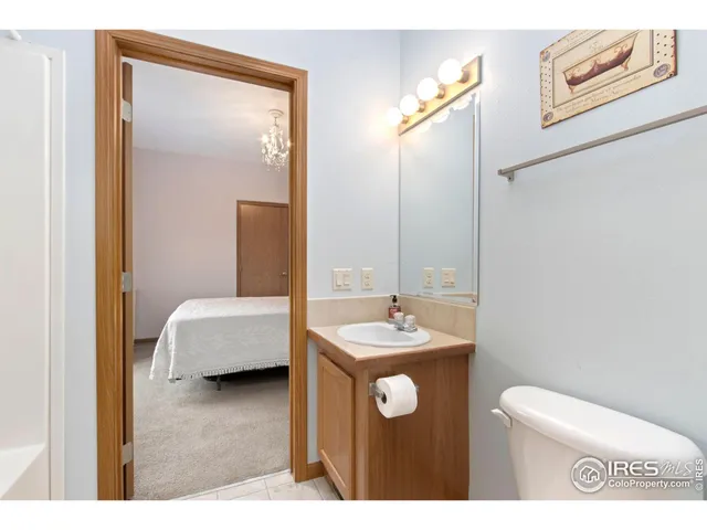 a en suite bathroom with a toilet sink and mirror